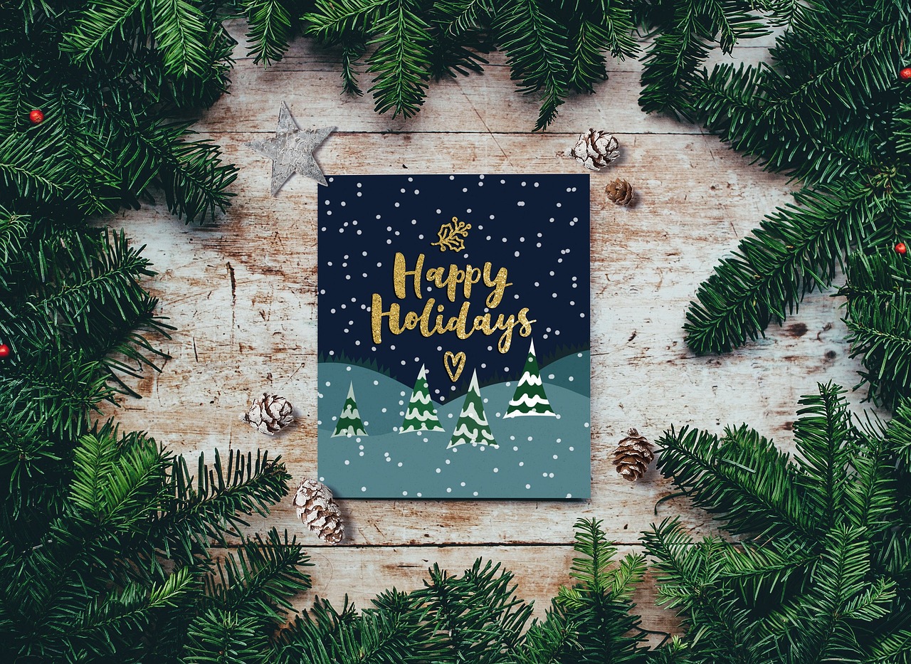 Happy Holidays Sign surrounded by pine branches